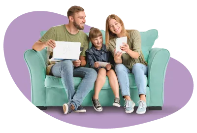 A family sat on a sofa all using devices